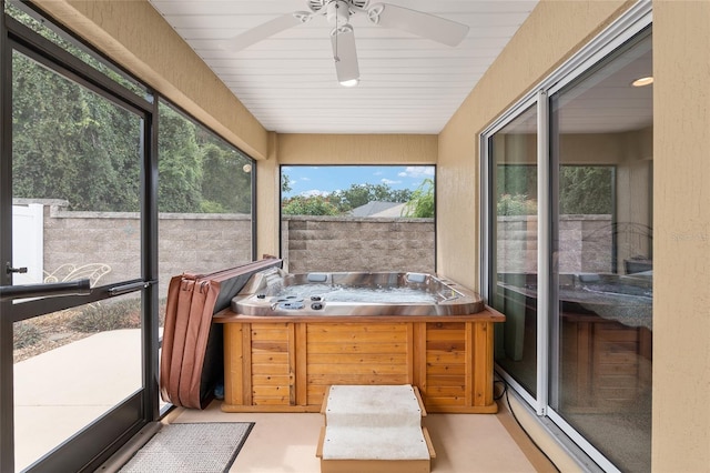 sunroom featuring ceiling fan, wood ceiling, and a hot tub