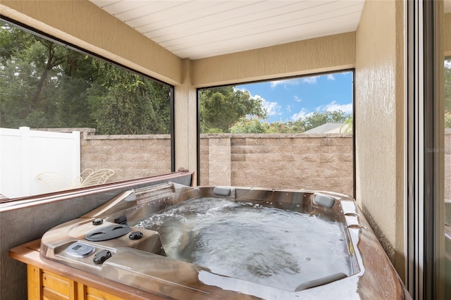 sunroom with a hot tub