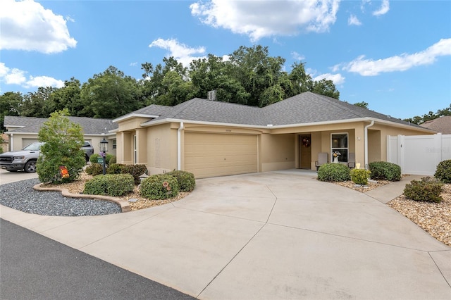 single story home featuring stucco siding, an attached garage, a shingled roof, and driveway