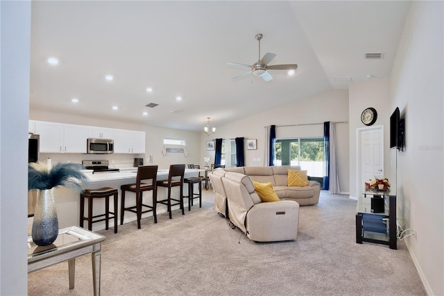 living room featuring vaulted ceiling, ceiling fan, and light colored carpet