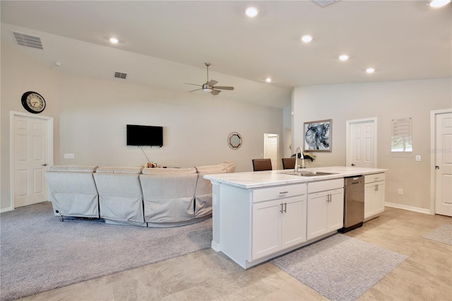 kitchen with an island with sink, white cabinets, ceiling fan, stainless steel dishwasher, and sink