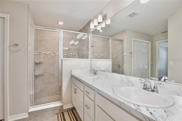 bathroom with vanity, an enclosed shower, and tile patterned floors