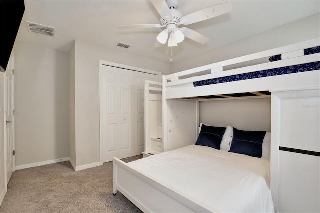 bedroom featuring light carpet, a closet, and ceiling fan