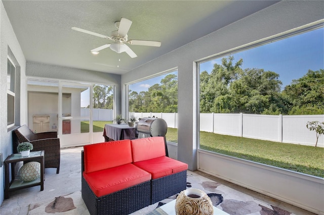 sunroom / solarium featuring ceiling fan