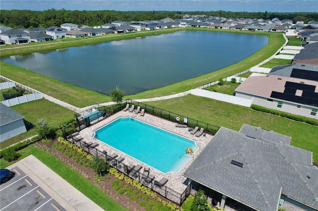 view of pool featuring a lawn and a water view