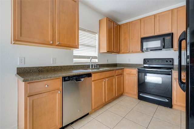 kitchen featuring black appliances, sink, and light tile patterned flooring