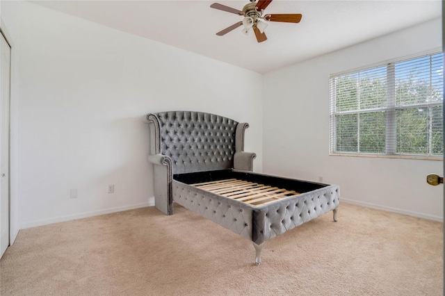 carpeted bedroom featuring ceiling fan