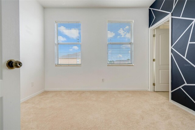 carpeted empty room with a healthy amount of sunlight