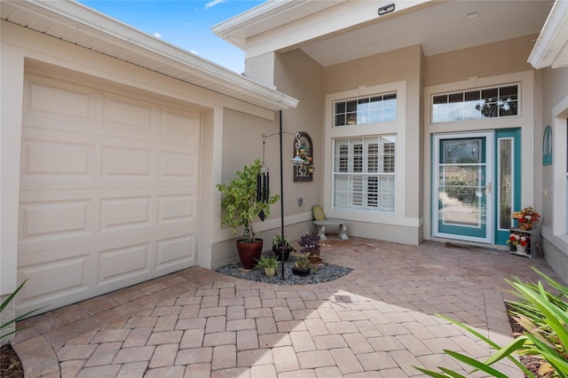 doorway to property with a garage