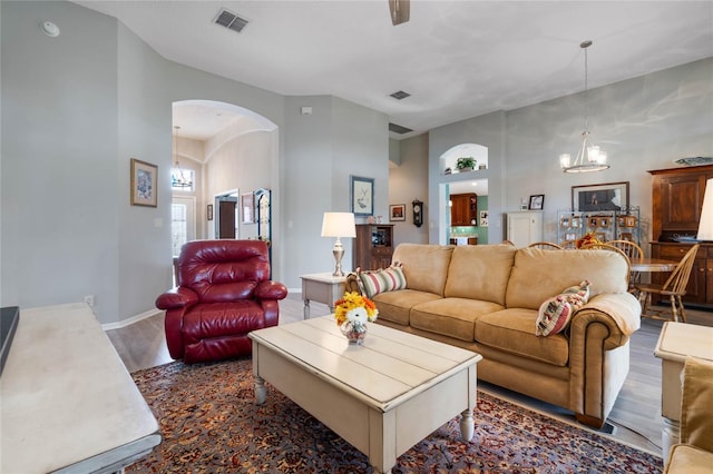 living room featuring dark wood-type flooring and a notable chandelier