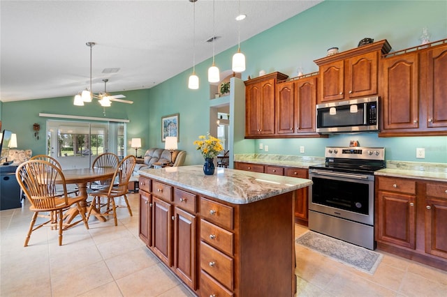 kitchen featuring pendant lighting, a center island, stainless steel appliances, lofted ceiling, and ceiling fan