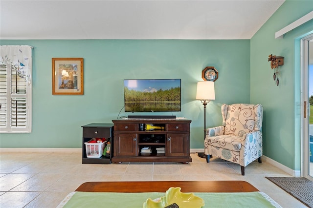 living room featuring lofted ceiling and light tile patterned floors