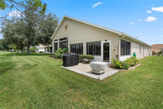 rear view of property featuring a lawn