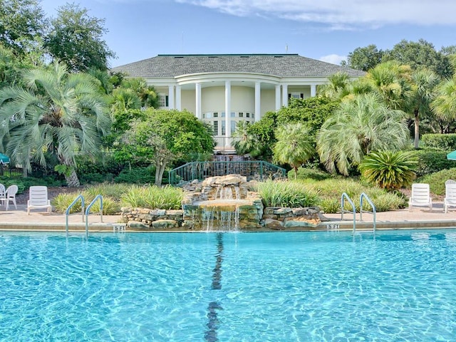 view of pool with pool water feature