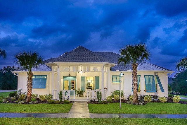 view of front of house with a front yard and a porch