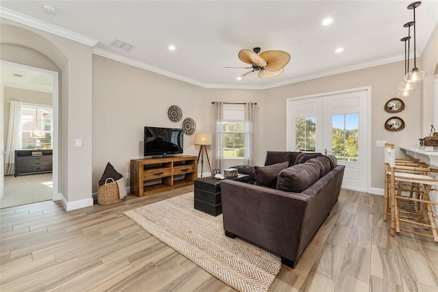 living room featuring ornamental molding, light hardwood / wood-style flooring, and ceiling fan