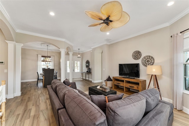 living room with ornamental molding, ornate columns, and light hardwood / wood-style floors