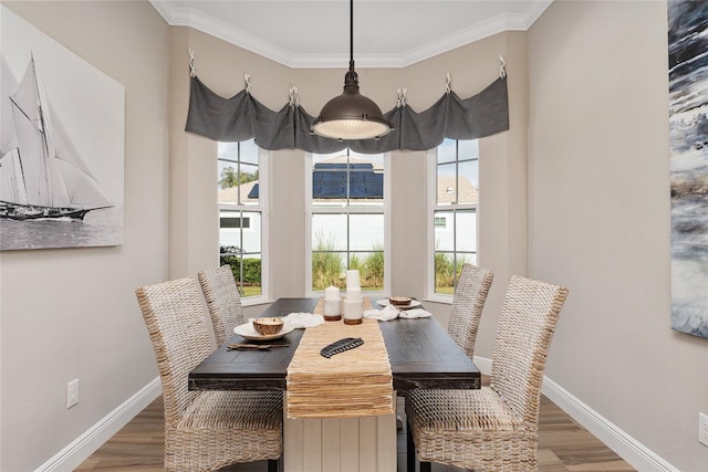 dining area with ornamental molding and hardwood / wood-style floors