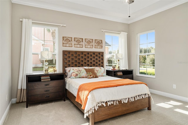 carpeted bedroom featuring crown molding and ceiling fan