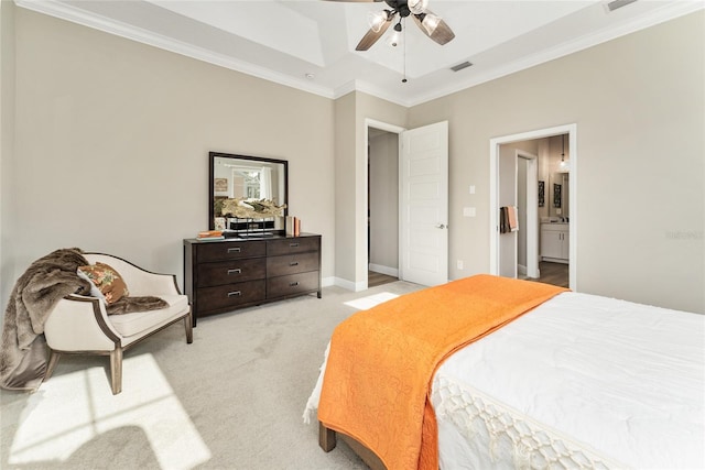 bedroom featuring crown molding, ceiling fan, ensuite bathroom, and light colored carpet