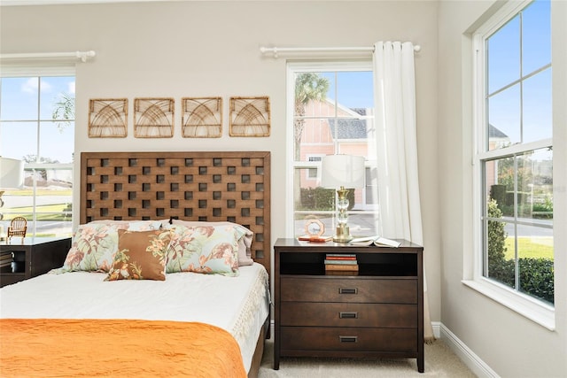 carpeted bedroom featuring multiple windows