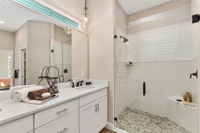 bathroom featuring vanity and a shower with shower door