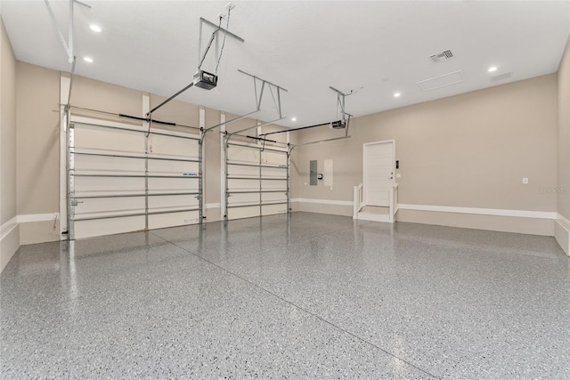 garage featuring a garage door opener and electric panel