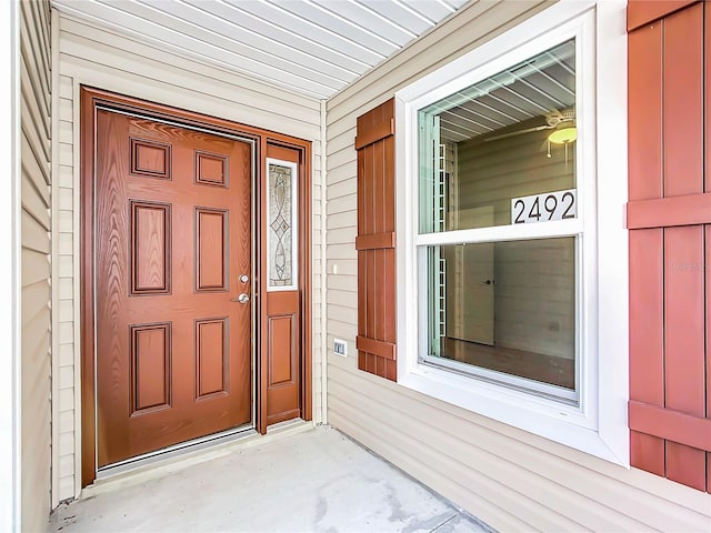 view of exterior entry featuring covered porch