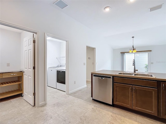 kitchen with washer and clothes dryer, dishwasher, sink, hanging light fixtures, and dark brown cabinetry