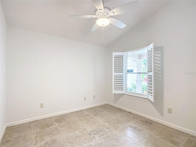 empty room with ceiling fan, light tile patterned floors, and vaulted ceiling