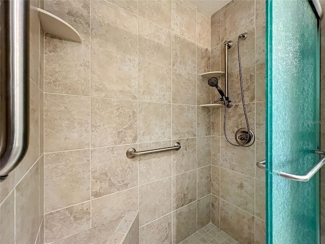 bathroom featuring a shower with door