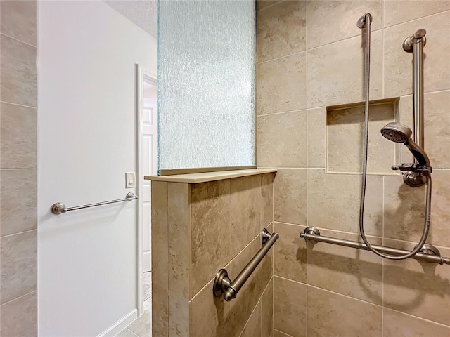 bathroom with a tile shower