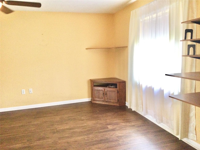 spare room featuring ceiling fan and dark hardwood / wood-style floors