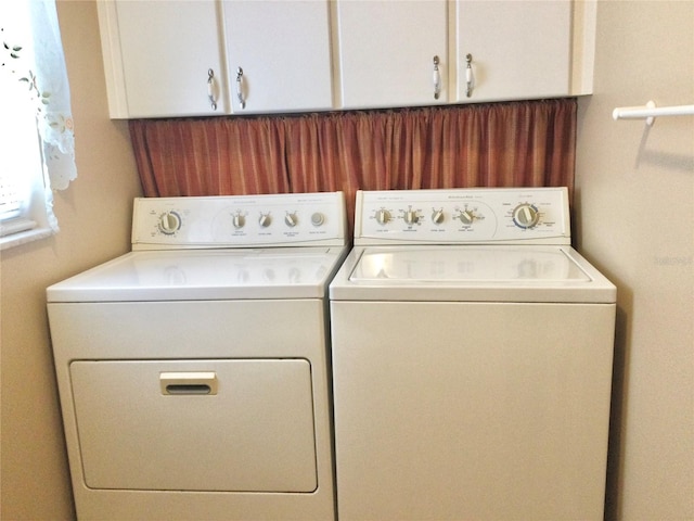 laundry room with cabinets and washer and dryer