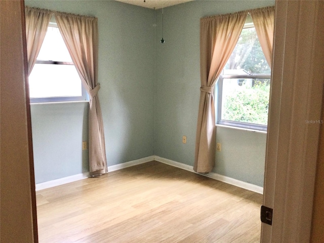 unfurnished room with light hardwood / wood-style floors