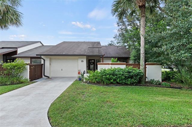 view of front of house with a garage and a front lawn