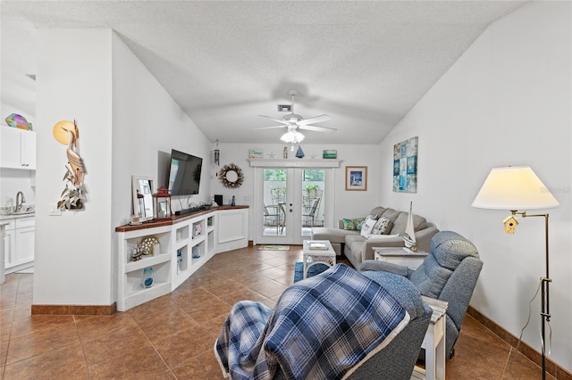 living room featuring ceiling fan, sink, lofted ceiling, and french doors