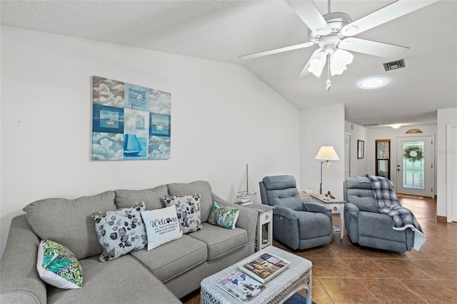 tiled living room featuring a textured ceiling, vaulted ceiling, and ceiling fan