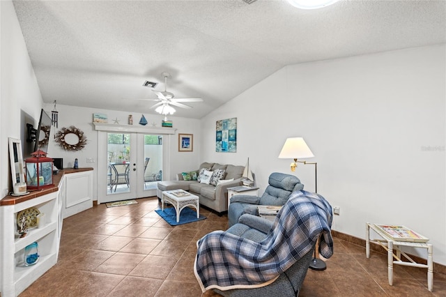 tiled living room featuring a textured ceiling, vaulted ceiling, ceiling fan, and french doors