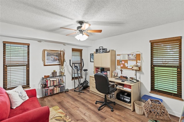 office with a textured ceiling, hardwood / wood-style floors, and ceiling fan