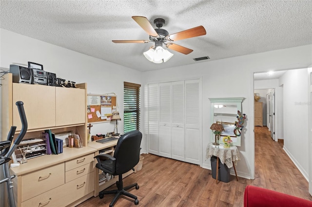 office area featuring ceiling fan, hardwood / wood-style flooring, and a textured ceiling