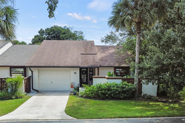 view of front facade with a front yard and a garage