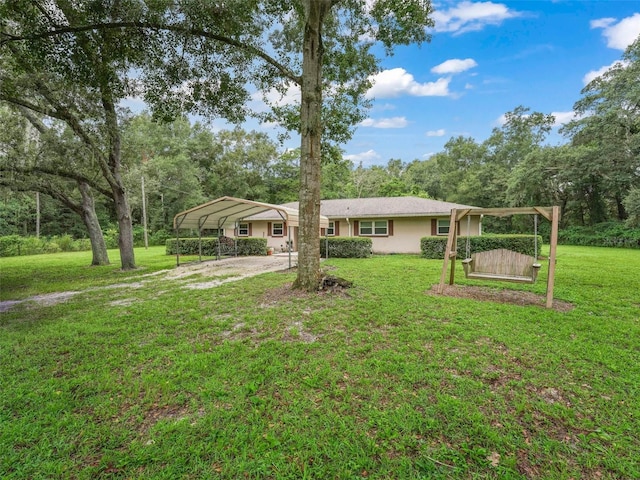 single story home with a front lawn and a carport