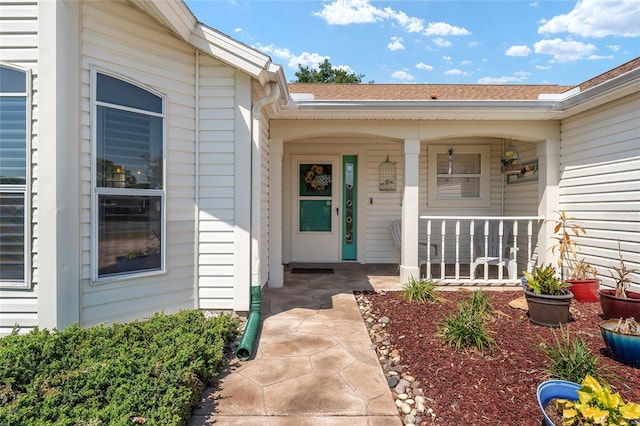 view of exterior entry featuring a porch