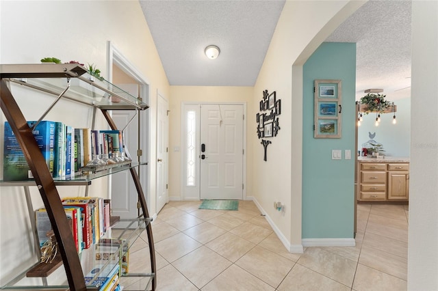 tiled foyer entrance with a textured ceiling