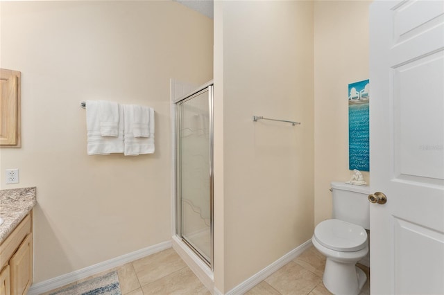 bathroom featuring tile patterned flooring, vanity, toilet, and a shower with shower door