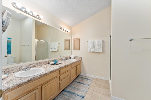 bathroom featuring toilet, an enclosed shower, tile patterned flooring, vanity, and a textured ceiling