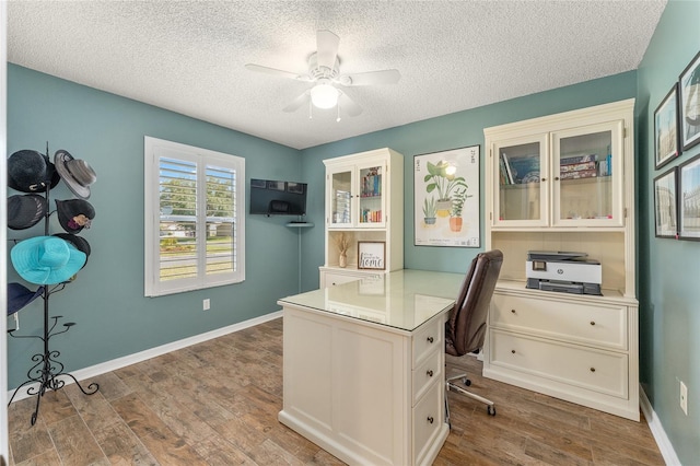 office area with a textured ceiling, hardwood / wood-style floors, and ceiling fan