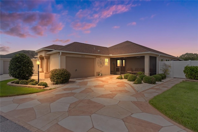 view of front of house with a yard and a garage