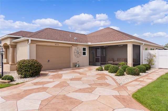 view of front of house featuring a garage and a sunroom